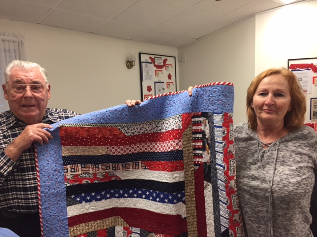 Jim Quigley was awarded a Quilt of Valor from Cathy Elliott. 